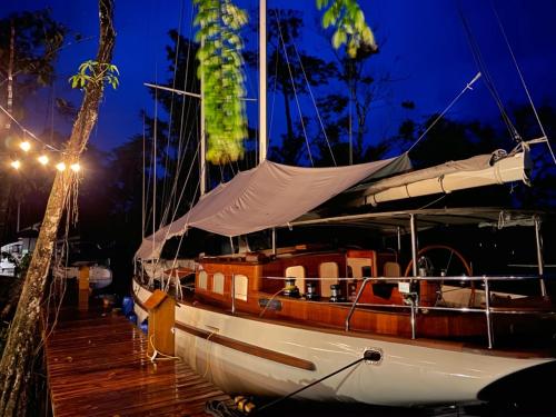 a boat parked on a dock at night at Boatique Hotel and Marina in Rio Dulce