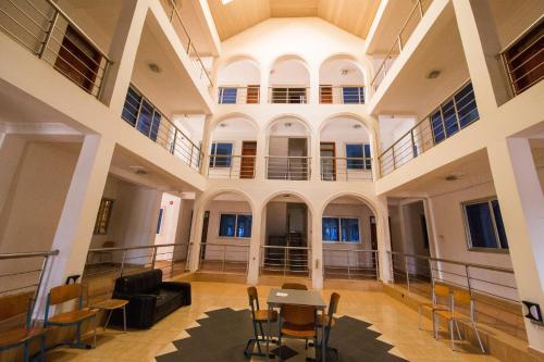 a large hall with a table and chairs in a building at Pemicsa Hotel Accra in Spintex