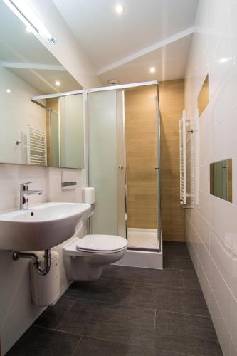 a bathroom with a sink and a toilet and a shower at Zajazd Magnolia-Airport Modlin in Pomiechówek