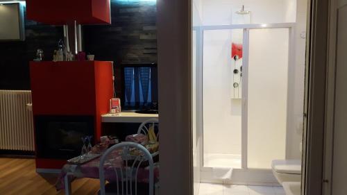 a kitchen with a red cabinet and a bathroom at La Mansardina in Matera