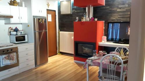 a kitchen with a red refrigerator and a table in it at La Mansardina in Matera