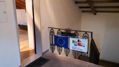 a stairway with a flag banner on a railing at La Mansardina in Matera