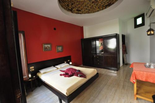 a bedroom with a bed with a stuffed animal on it at El Nakhil Hotel in Luxor