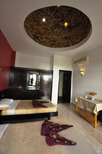 a bedroom with a bed and a table with a sink at El Nakhil Hotel in Luxor