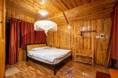 A bed or beds in a room at Jungle Boss Homestay