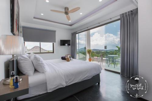 a bedroom with a large bed and a large window at Villa Azur, 4 Bedrooms, Ocean View in Chaweng