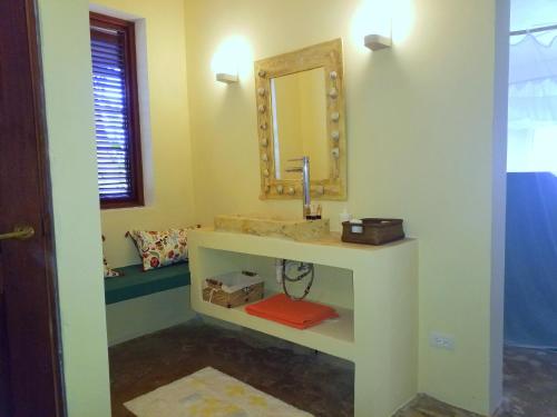 a bathroom with a sink and a mirror at Villa Los Gorgones in Las Galeras