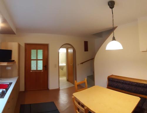 a living room with a table and a kitchen at Haus Königshofer in Neusiedl am See