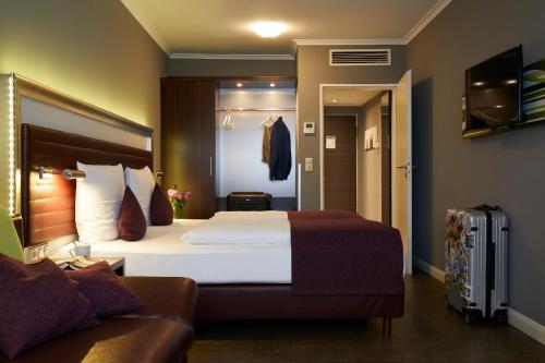 Ein Bett oder Betten in einem Zimmer der Unterkunft Hotel Metropol by Maier Privathotels