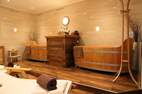 a large room with two tubs in a room at Hotel La Passionaria in Mariánské Lázně