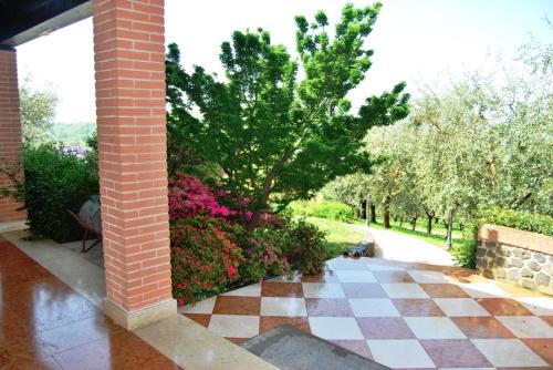 a brick building with a checkered floor in a garden at Tenuta Fortelongo in Fara Vicentino