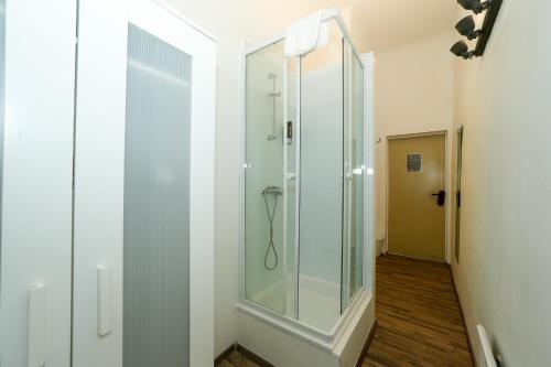 a shower in a bathroom with a glass door at Timeout City Hotel, 5 min to city center, Self Check In in Vienna