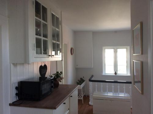 a kitchen with a tv on a counter and a window at Marielyst B&B - Apartments in Næstved