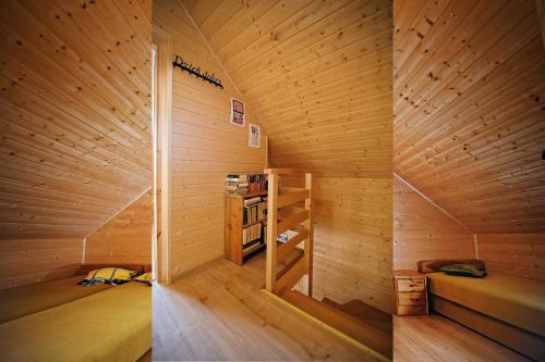 a small room with a bed and a book shelf at Komandorówka in Szczawne