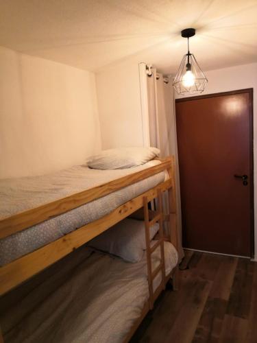 - une chambre avec des lits superposés et une porte dans l'établissement Poutran 2, studio 4 personnes au pied des pistes avec grande terrasse, à Oz
