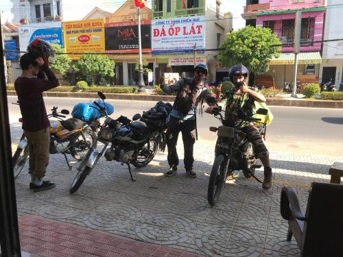 a group of people on motorcycles on a city street at Hoa Mai Hotel in Dong Hoi