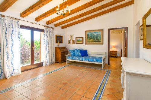 a living room with a blue couch and a window at C262 Can Moleta by Mallorca Villa Selection in Cala Mendia