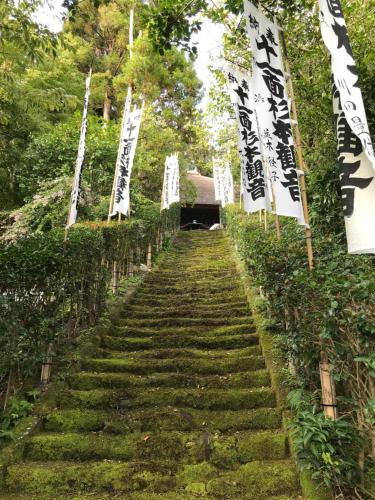 a stairway with signs and flags on it at Children's cafe B&B Kimie in Kamakura