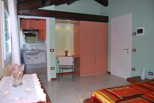 a bedroom with a kitchen with a sink and a table at Tenuta Fortelongo in Fara Vicentino