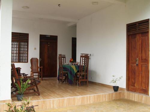 a dining room with a table and chairs at lake paradise in Habaraduwa
