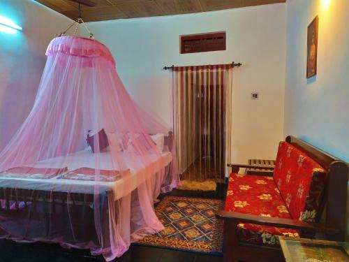 a bedroom with a bed with a mosquito net at Sea Hut Homestay in Cochin