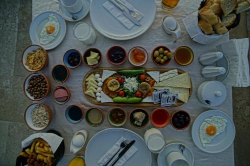 a table topped with plates of food and bowls of food at Termessos Hotel in Goreme