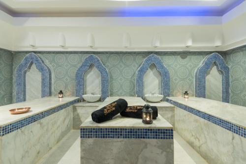a bathroom with two sinks and two mirrors at Imperial Shams Abu Soma in Hurghada
