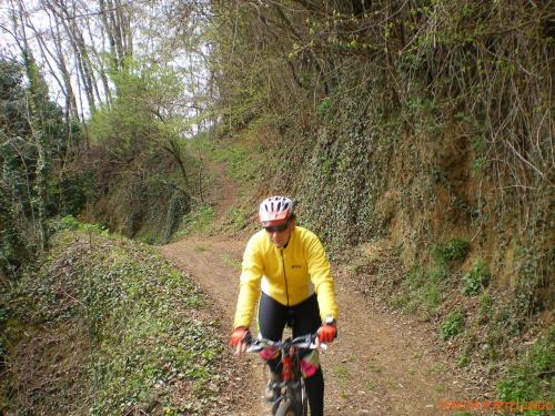 a man riding a bike on a dirt road at Tenuta Fortelongo in Fara Vicentino