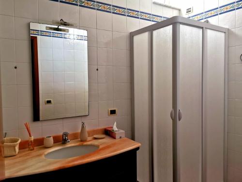 a bathroom with a sink and a mirror at Villa Amelie (Mare e Relax) in Bisceglie