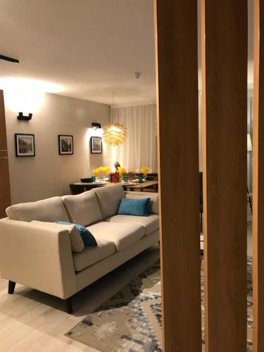 a living room with a white couch and a table at Riverside apart in Blagoevgrad