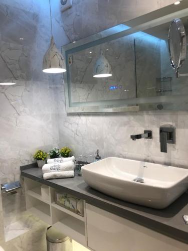 a bathroom with a sink and a mirror at Riverside apart in Blagoevgrad