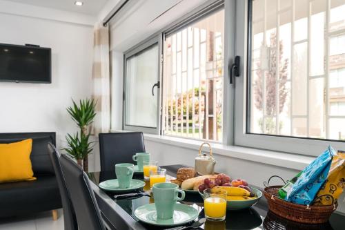 a dining room table with breakfast foods on it at ImpervillaStudio - Vilamoura City Centre in Quarteira