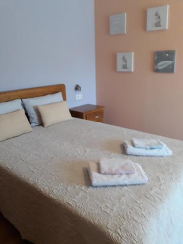 um quarto com uma cama com duas toalhas em Cynda´s home em Viseu