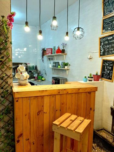 a kitchen with a counter with a bench and lights at Villa Fifari - 5 Kamar Tidur, 3 Kamar Mandi in Batu