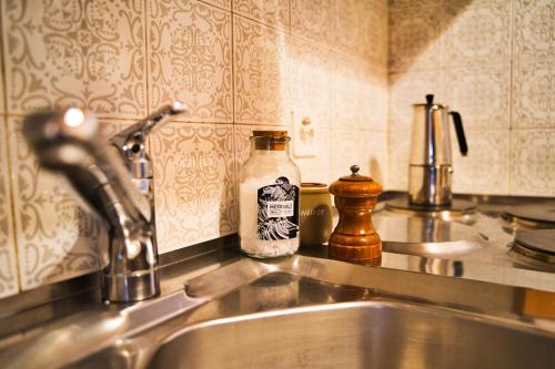 a kitchen counter with a sink and a bottle of soap at Große Wohnung mitten in St. Moritz am See in St. Moritz