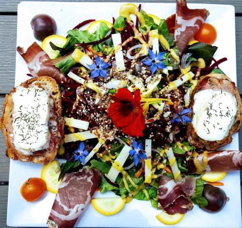 a plate of food with a salad and bread at Le Pic de Pan - Auberge & Gîtes in Arrens-Marsous