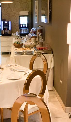 a kitchen with a table with plates of food at Hotel Masaniello Luxury in Casoria