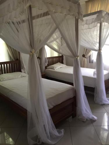 Katil atau katil-katil dalam bilik di Amani Villa