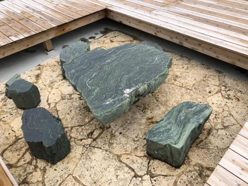a group of rocks on the ground next to a bench at Ocean Villa Okinoerabu in Wadomari