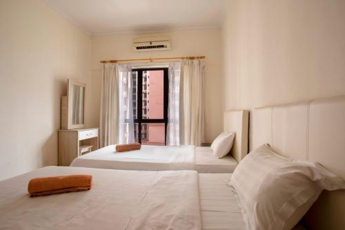 a bedroom with two beds and a window with a view at Marina Court Kota Kinabalu-STAY AND GET CASH REBATE in Kota Kinabalu