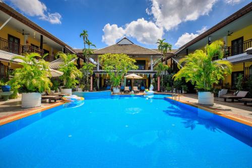 a large swimming pool in front of a building at Vdara Pool Resort Spa Chiang Mai in Chiang Mai
