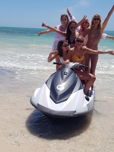 a group of women on a jet ski on the beach at Menzel Churasco Djerba in Aghīr