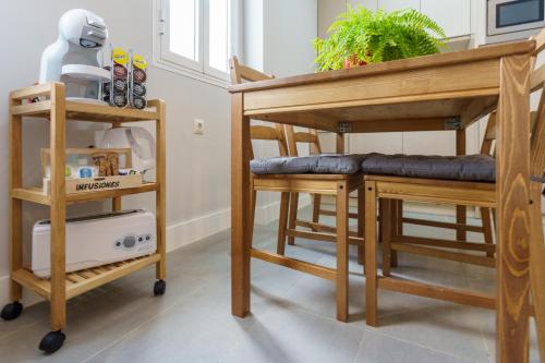 a room with a bunk bed and two stools at Apartamentos Circulo De Artistas in Ronda