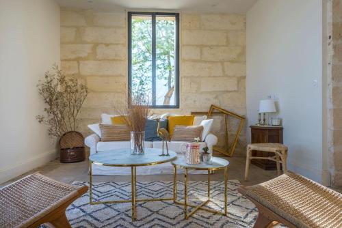 a living room with a couch and a table at Domaine la Clausade in Mauguio