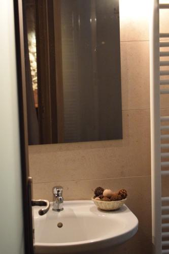 a bathroom sink with a bowl of fruit on it at Hagiati Anastasiou Hotel & Spa in Naousa Imathias