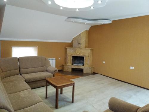 a living room with a couch and a fireplace at DownTown B&B in Vanadzor