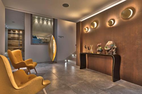 a lobby with chairs and a table in a room at Esplanade Tergesteo - Luxury Retreat in Montegrotto Terme