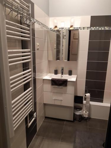 a bathroom with a sink and a mirror at Smile in Dieppe