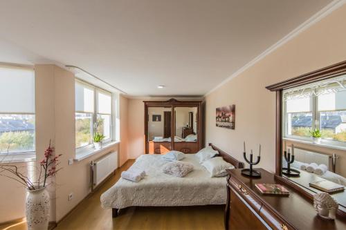 a bedroom with a bed and a desk and windows at Super comfort flat for you near the metro. in Kyiv