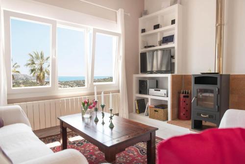 a living room with a coffee table and two windows at Casa Bella Vista in Moraira